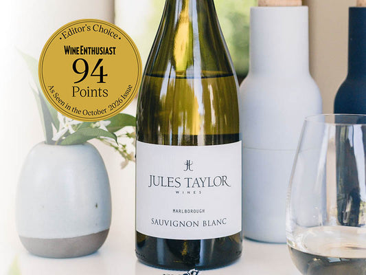 A bottle of Jules Taylor Marlborough Sauvignon Blanc with a medal sticker for scoring 94 points and editors pick in Wine Enthusiast Oct 2026 issue