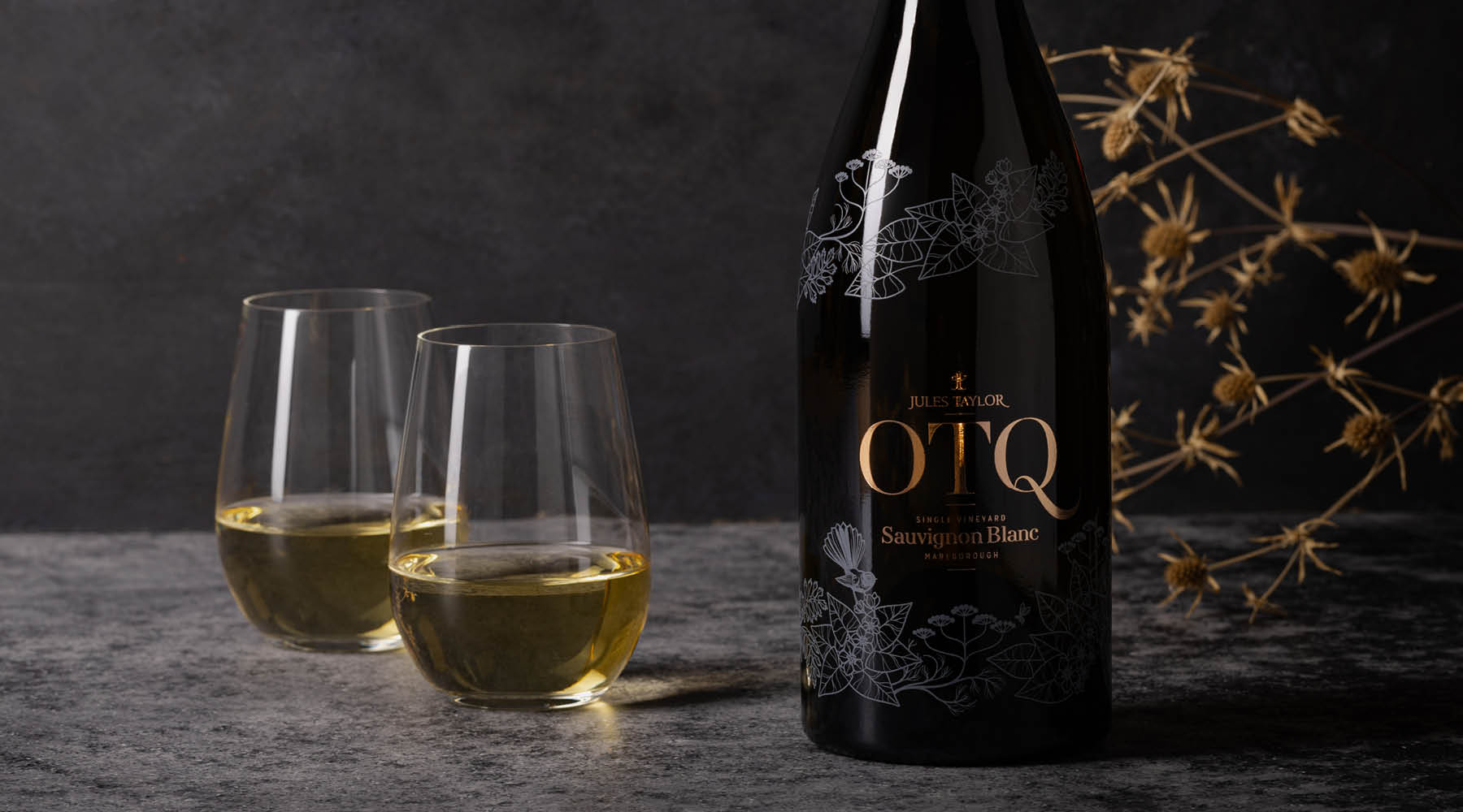 A bottle and glasses of On The Quiet Sauvignon Blanc wine